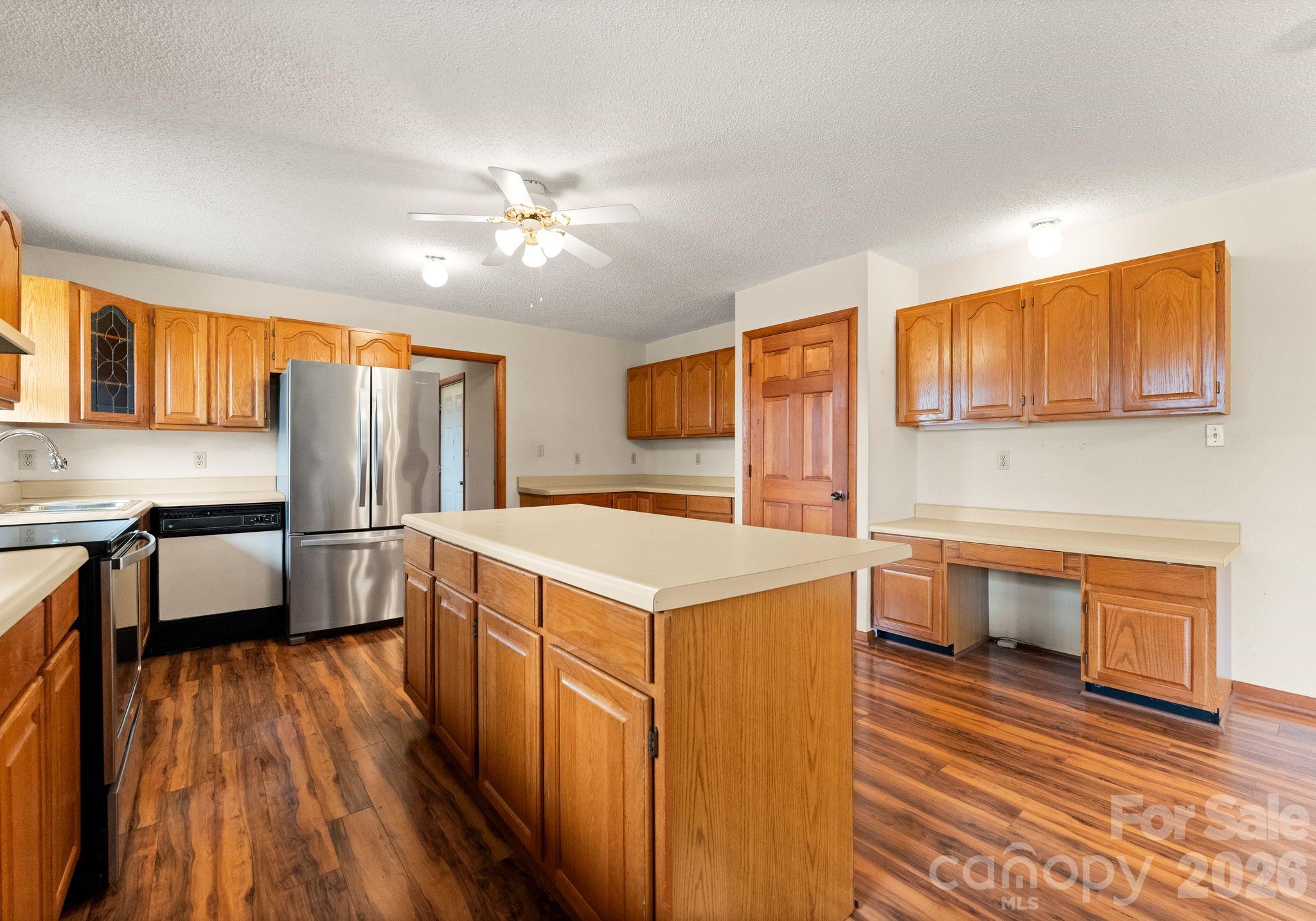 150 Barber Lyerly Road Salisbury, NC 28147 - Photo 7 of 43 a kitchen that has a lot of cabinets a sink and wooden floor