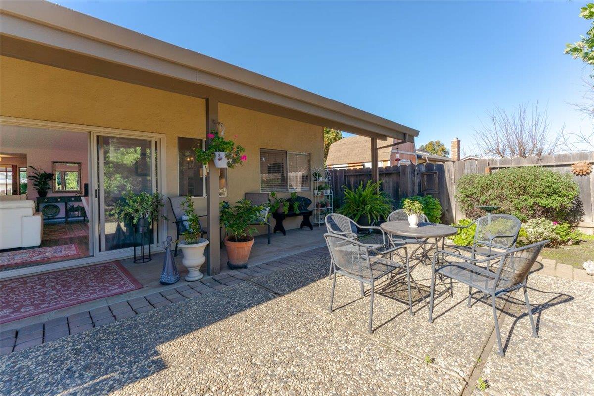7770 Laurel Drive Gilroy, CA 95020 - Photo 29 of 35 a view of a patio with table and chairs potted plants and floor to ceiling window