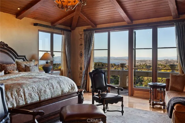 a bedroom with furniture and a floor to ceiling window