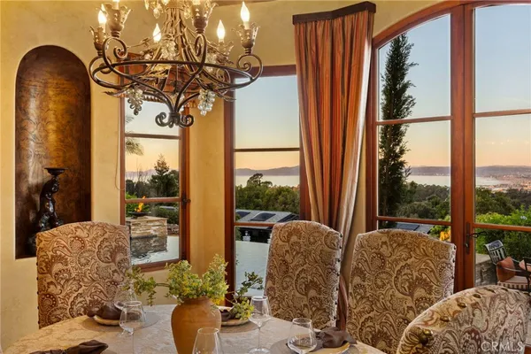 a living room with couches large window and wooden floor