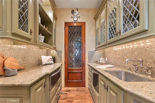 a bathroom with a granite countertop sink and a washing machine