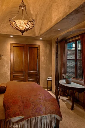 a bedroom with a bed and a chandelier