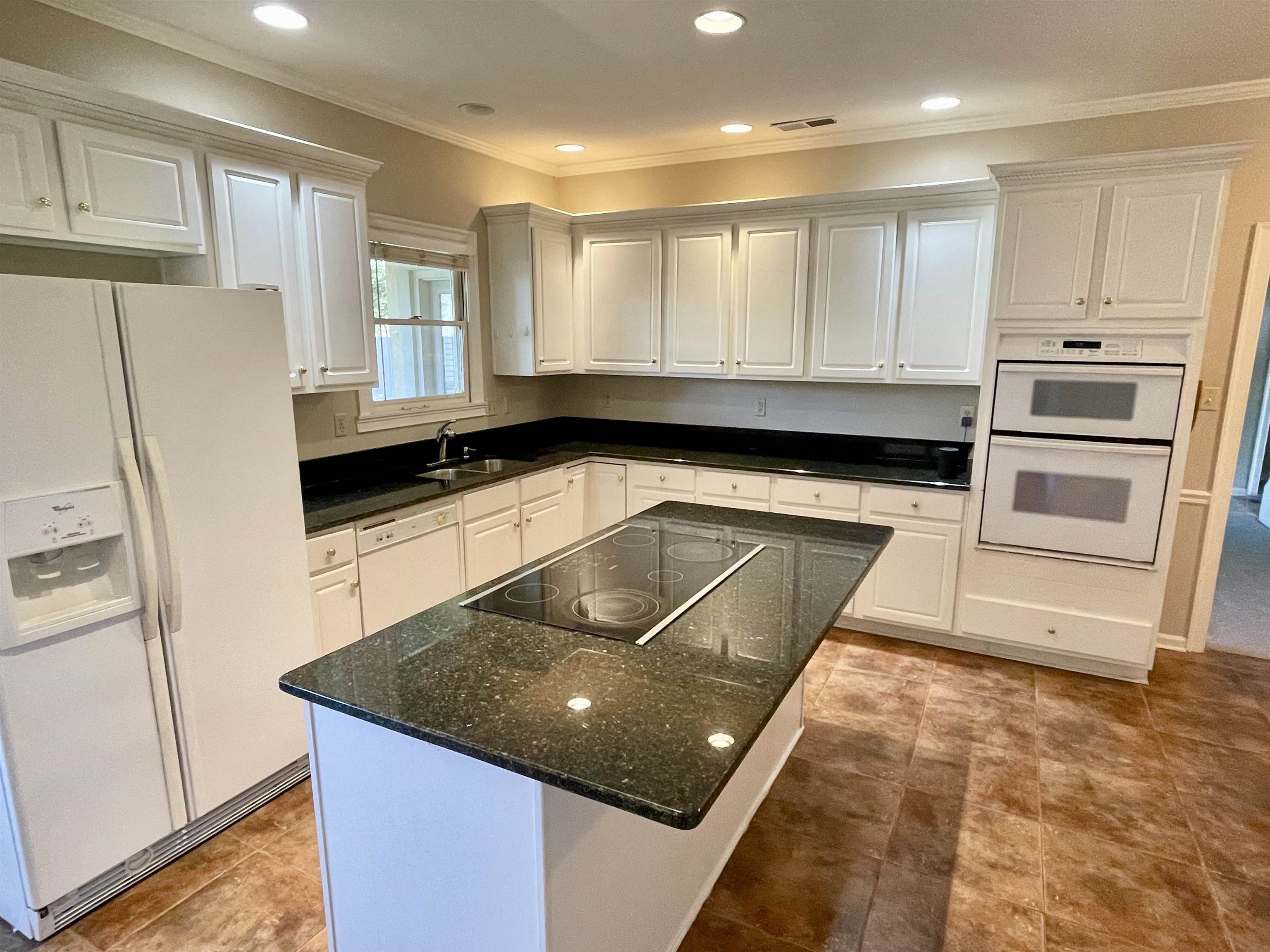 83 McCall Drive Collierville, TN 38017 - Photo 14 of 39 a kitchen with stainless steel appliances granite countertop a sink a stove a refrigerator and white cabinets
