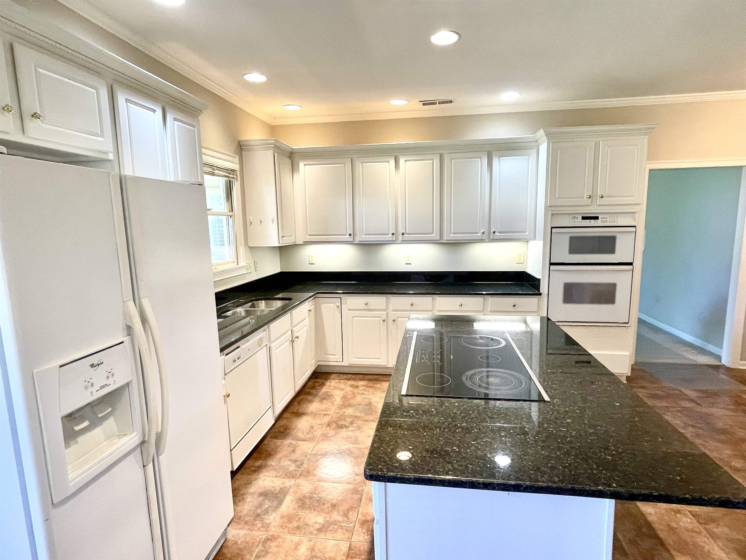 83 McCall Drive Collierville, TN 38017 - Photo 16 of 39 a kitchen with kitchen island granite countertop a refrigerator and a stove top oven
