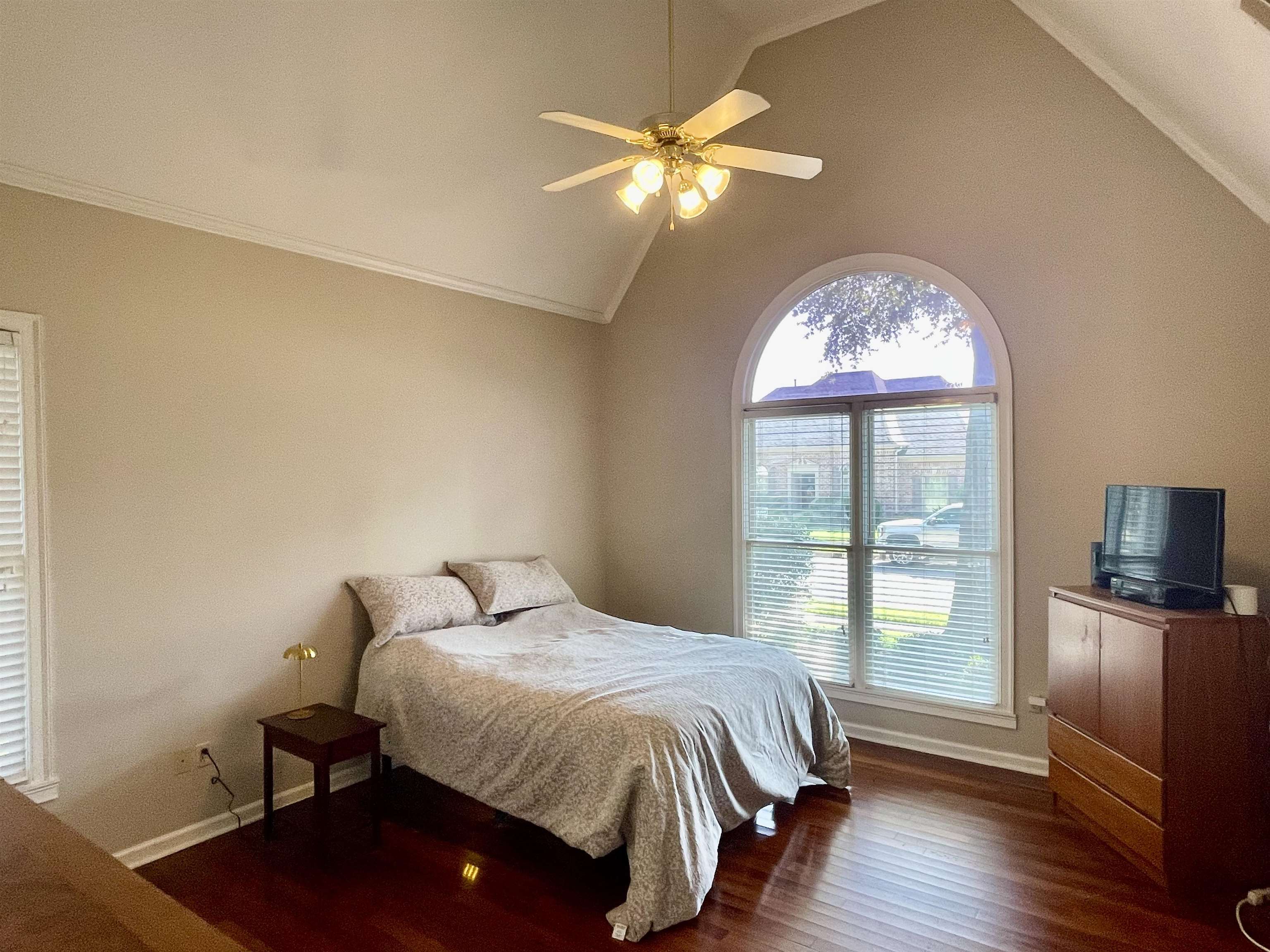 83 McCall Drive Collierville, TN 38017 - Photo 20 of 39 a bedroom with a bed and a chandelier