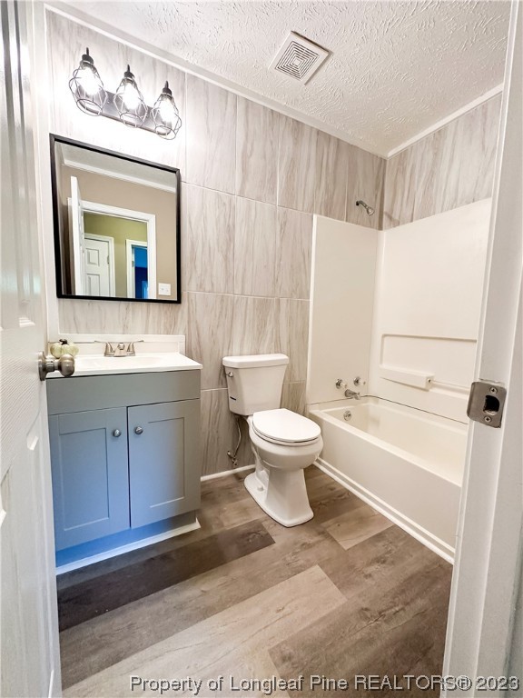 1645 Flintshire Road Fayetteville, NC 28304 - Photo 13 of 22 a bathroom with a toilet a sink a mirror a bathtub and vanity