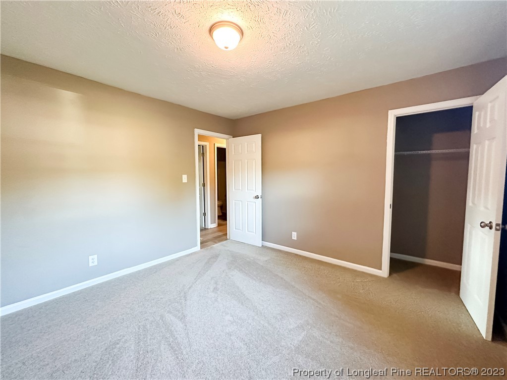 1645 Flintshire Road Fayetteville, NC 28304 - Photo 15 of 22 an empty room with closet and mirror
