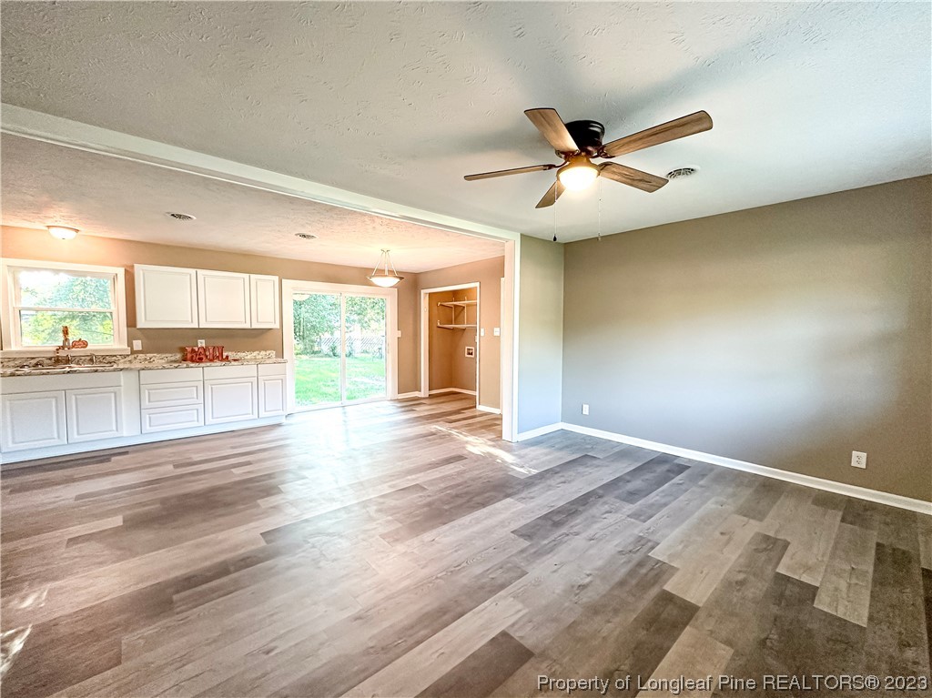 1645 Flintshire Road Fayetteville, NC 28304 - Photo 4 of 22 an empty room with wooden floor and windows