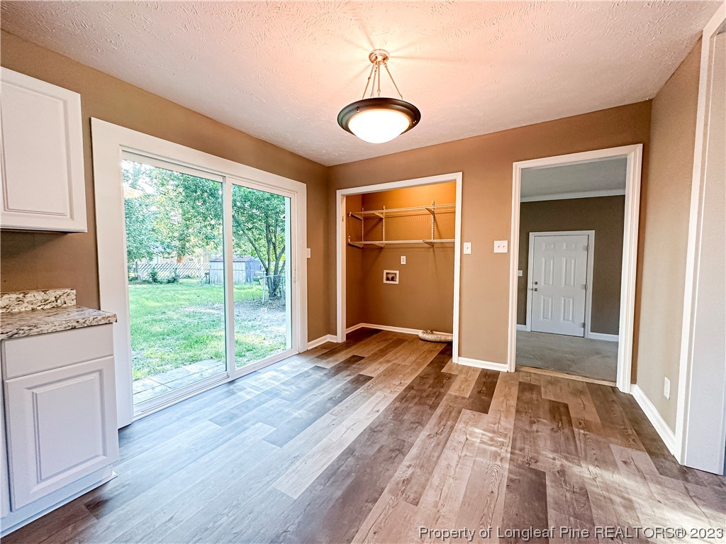 1645 Flintshire Road Fayetteville, NC 28304 - Photo 7 of 22 a view of empty room with wooden floor and fan