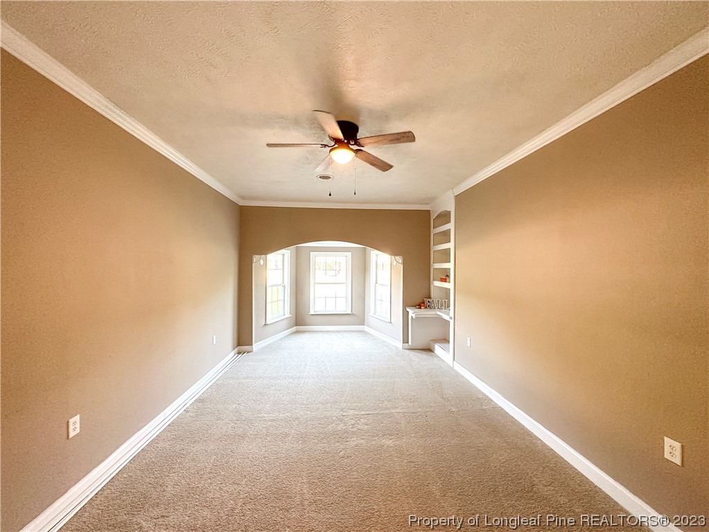 1645 Flintshire Road Fayetteville, NC 28304 - Photo 9 of 22 a view of a livingroom with a chandelier fan and windows
