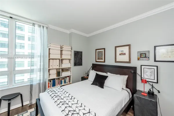 a bedroom with a bed furniture and a window