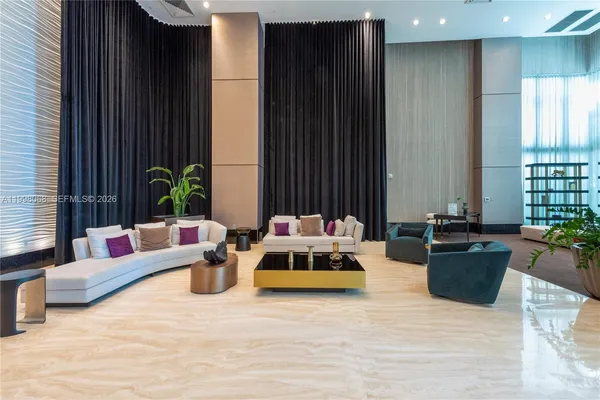 a living room with furniture and a potted plant