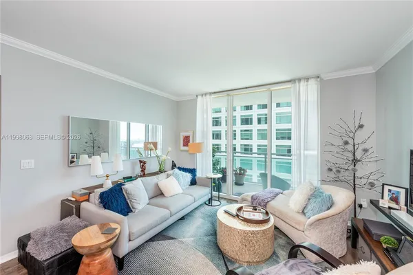 a living room with furniture and a large window