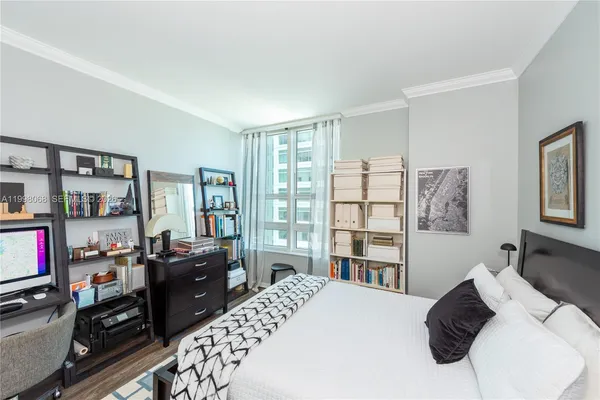 a bedroom with a bed furniture and a window