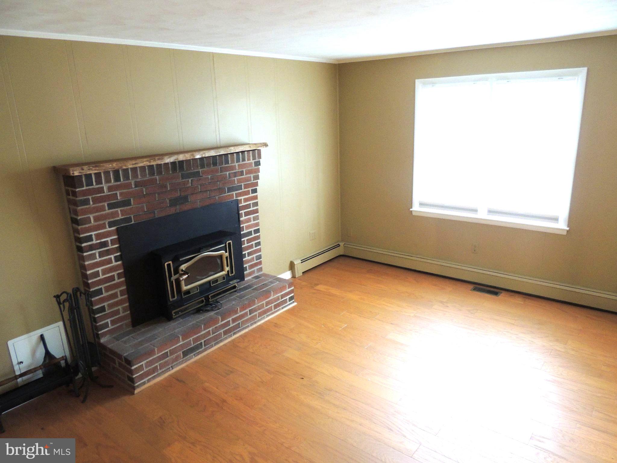 5838 Oklahoma Road Sykesville, MD 21784 - Photo 38 of 72 Cozy space with a charming fireplace.