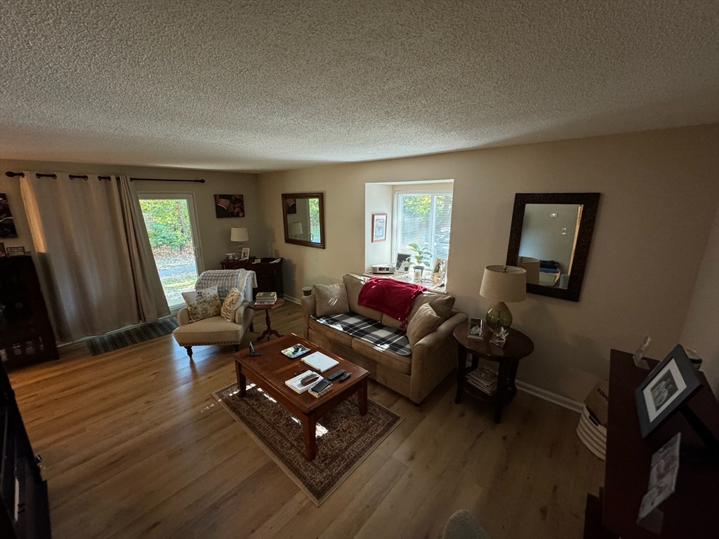 3 Beal's Cove Road, Unit H Hingham, MA 02043 - Photo 2 of 13 a living room with furniture rug and window