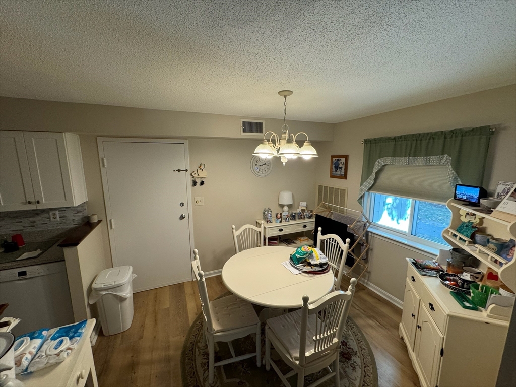 3 Beal's Cove Road, Unit H Hingham, MA 02043 - Photo 8 of 13 a view of a dining room with furniture and wooden floor