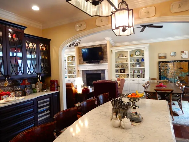 a living room with furniture a chandelier and a flat screen tv