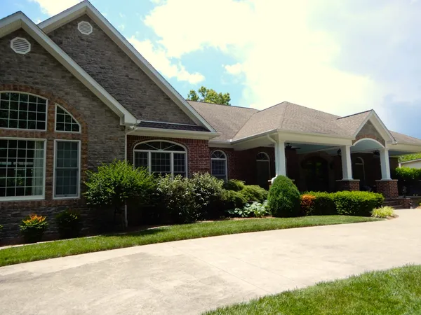 a front view of a house with large windows
