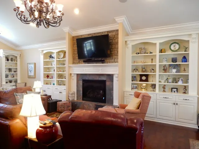 a bedroom with a bed a couch and a flat screen tv