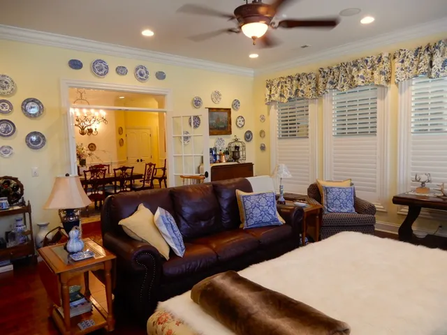 a bedroom with bed tv and window