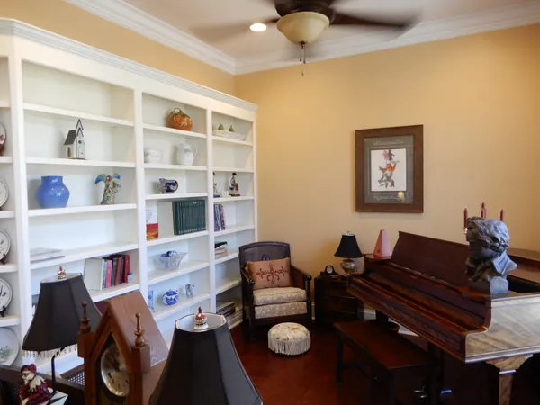 a front view of a house with a garden and trees