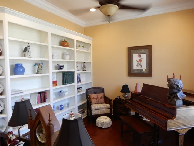 a front view of a house with a garden and trees