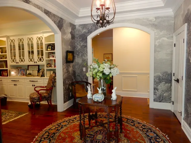 a bathroom with a sink a window and chairs