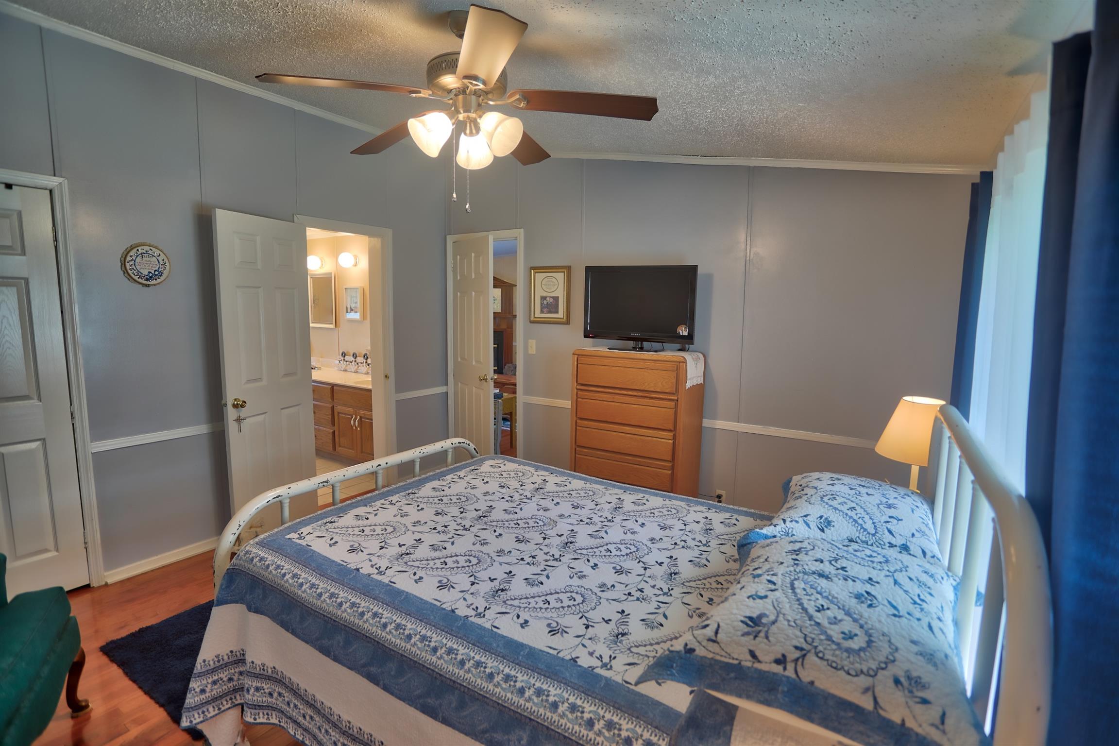 952 North Corinth Road Portland, TN 37148 - Photo 12 of 25 a bedroom with a bed and a flat screen television