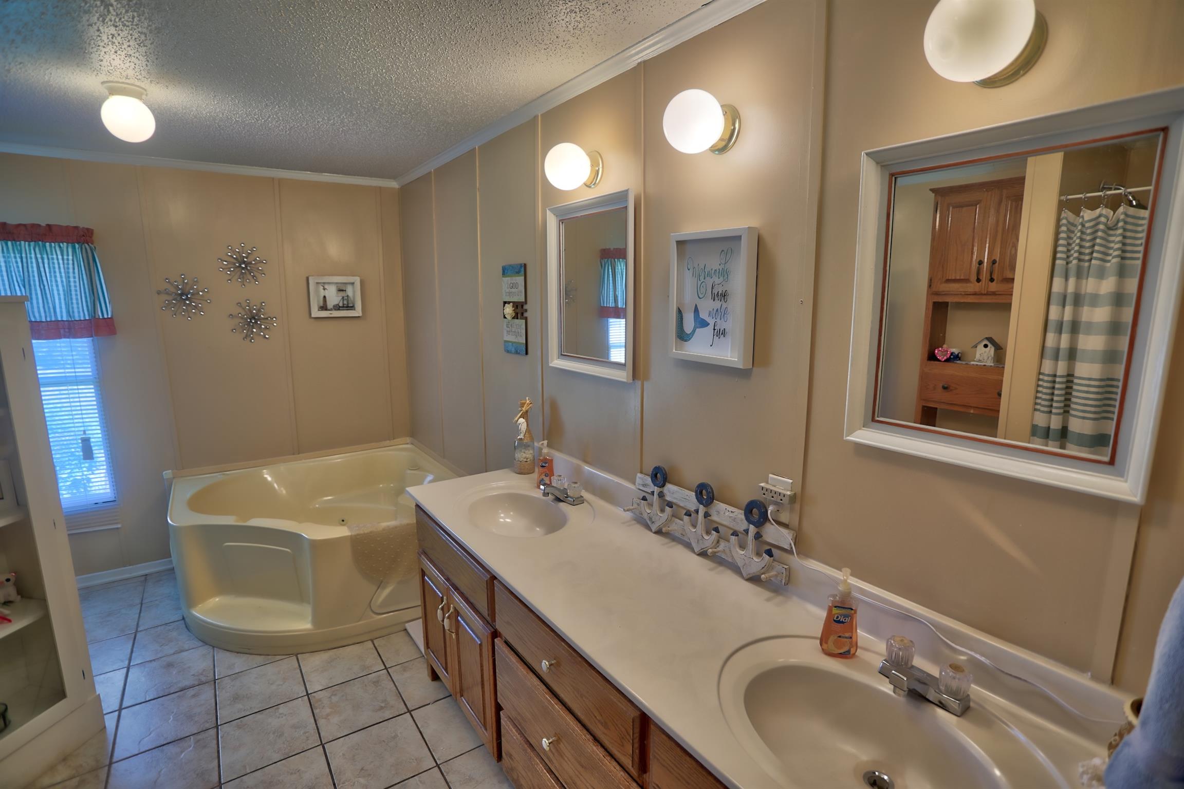 952 North Corinth Road Portland, TN 37148 - Photo 13 of 25 a bathroom with a sink a toilet and mirror
