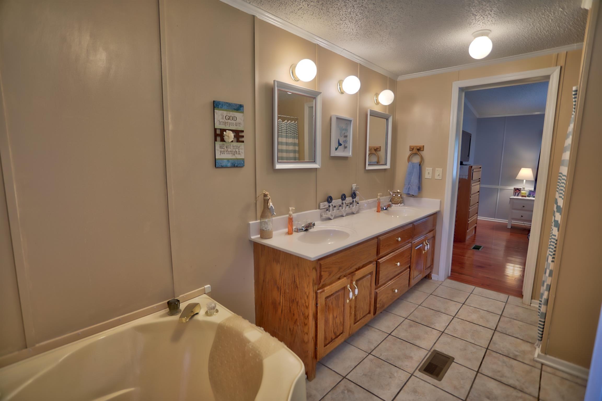 952 North Corinth Road Portland, TN 37148 - Photo 14 of 25 a bathroom with a sink double vanity and a mirror