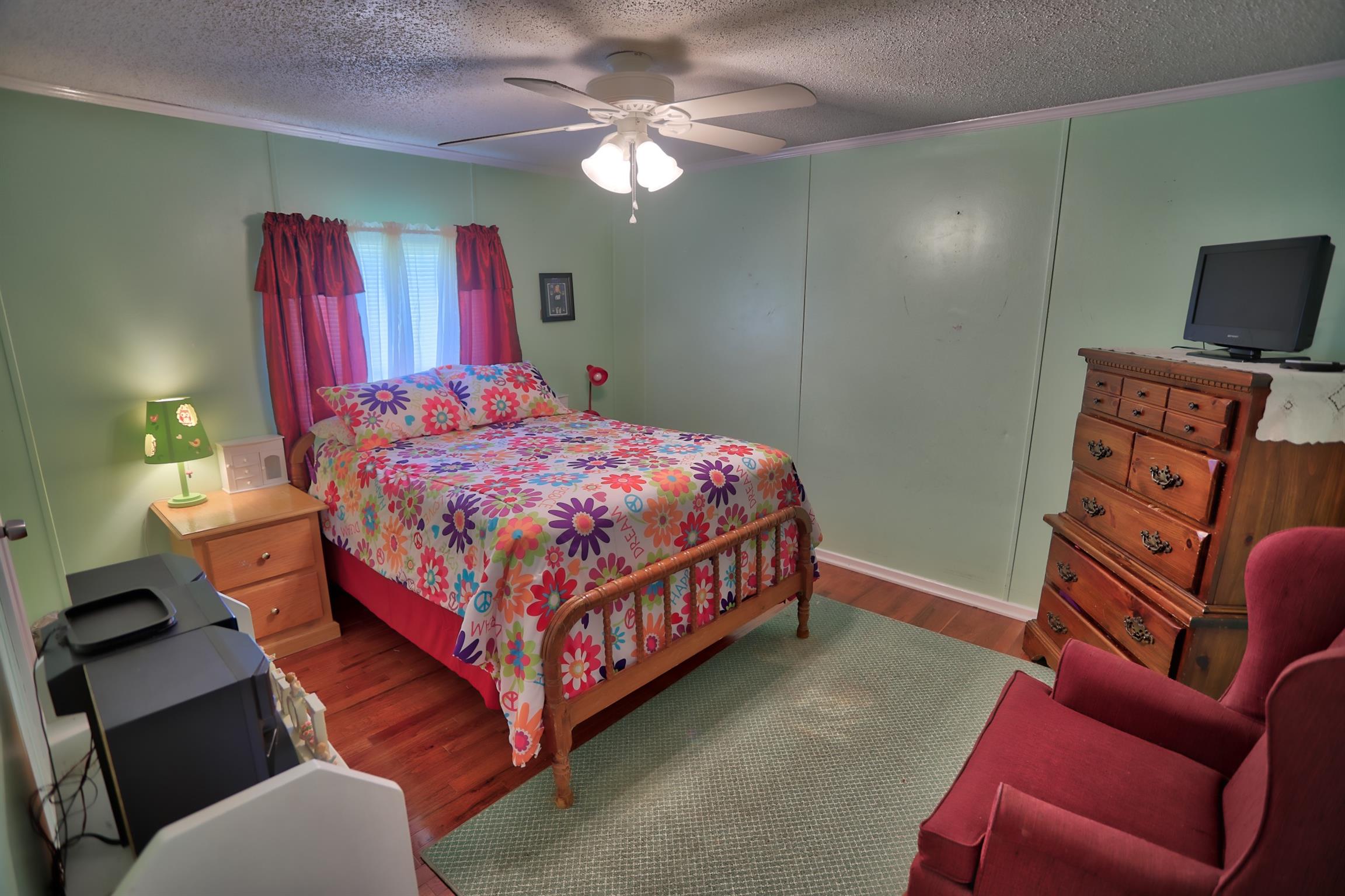 952 North Corinth Road Portland, TN 37148 - Photo 16 of 25 a bedroom with a bed and a chandelier