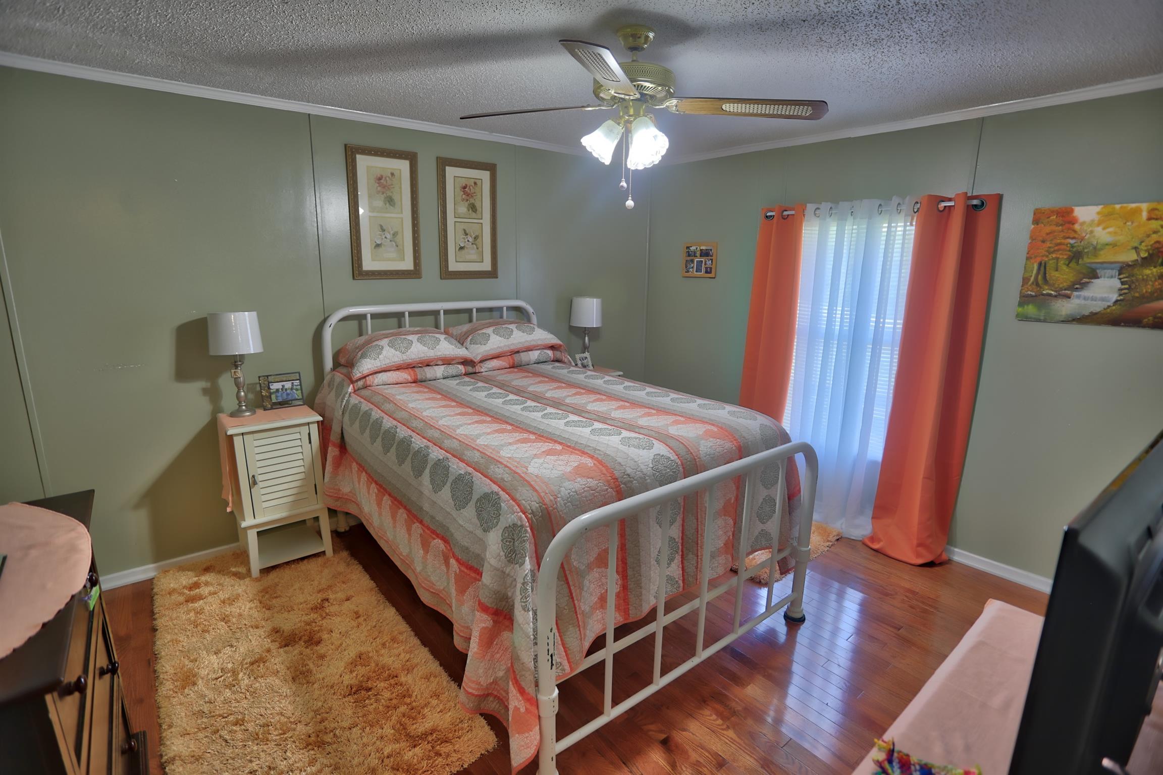 952 North Corinth Road Portland, TN 37148 - Photo 18 of 25 a bedroom with a bed and a chandelier