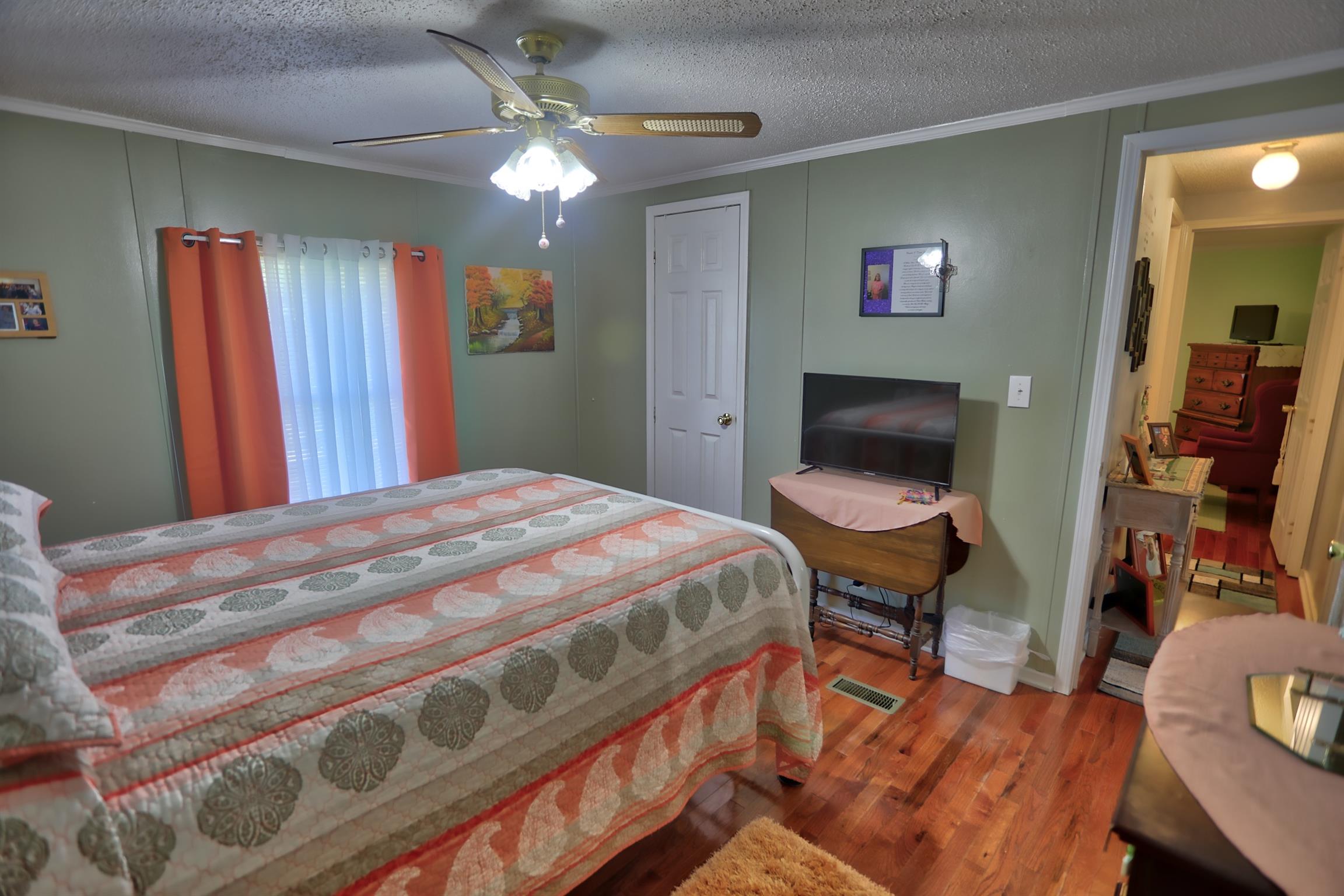 952 North Corinth Road Portland, TN 37148 - Photo 19 of 25 a bedroom with a bed and a chandelier