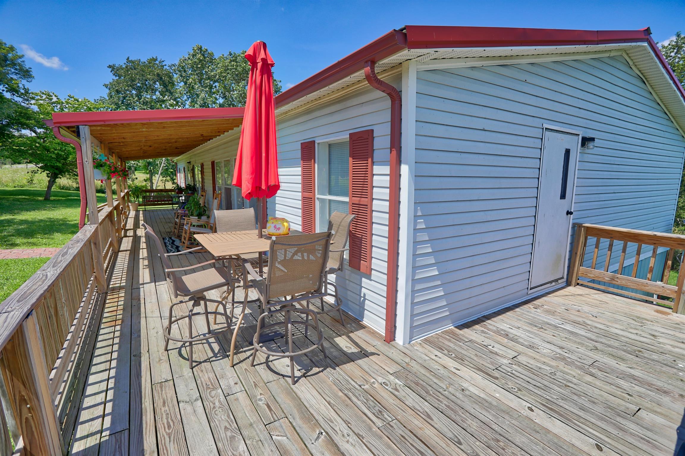 952 North Corinth Road Portland, TN 37148 - Photo 20 of 25 a roof deck with table and chairs a barbeque with wooden floor and fence