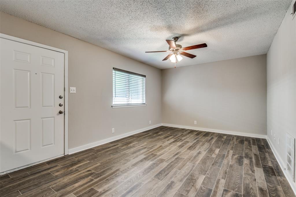 2211 West Hickory Street, Unit A4 Denton, TX 76201 - Photo 1 of 14 wooden floor in an empty room with a window