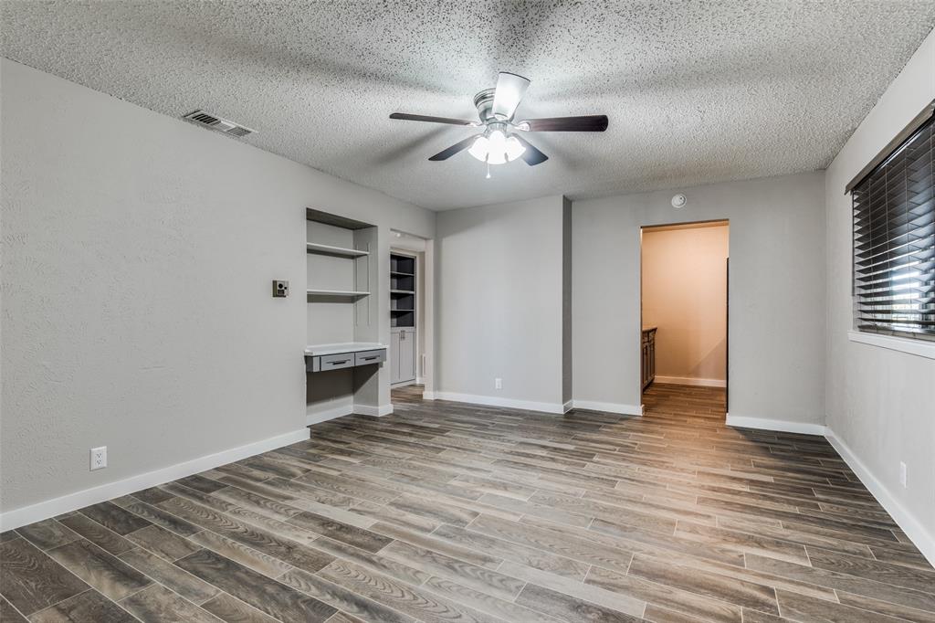 2211 West Hickory Street, Unit A4 Denton, TX 76201 - Photo 8 of 14 a view of an empty room with a window and fireplace