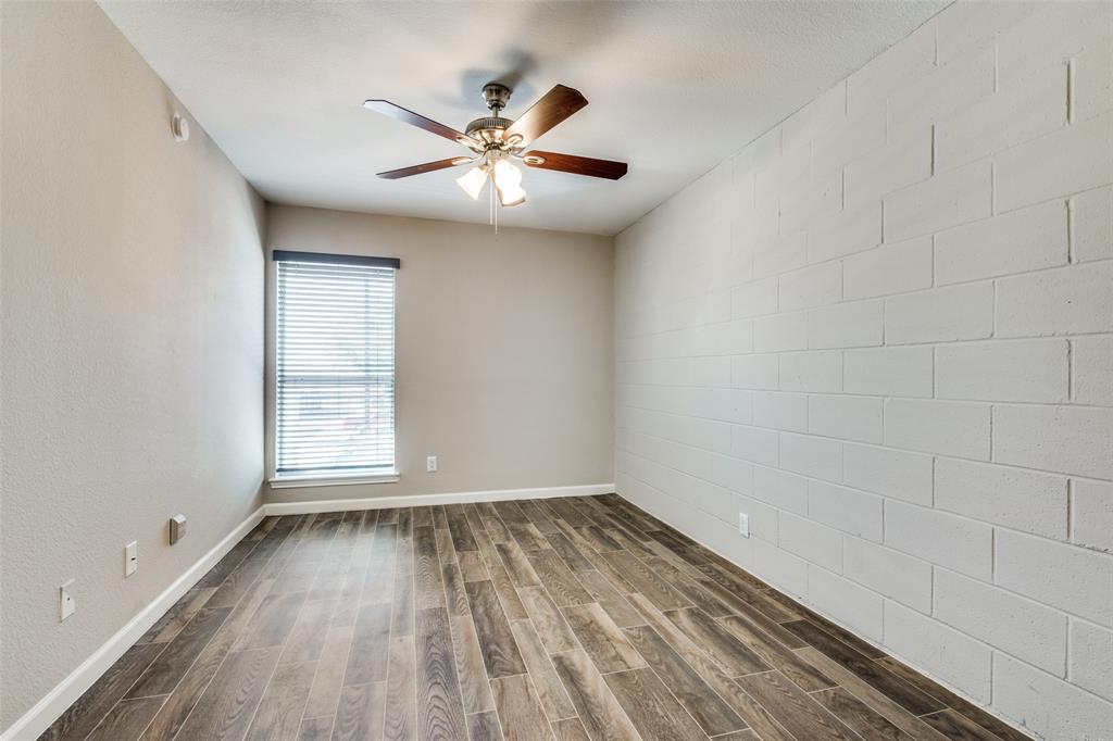 2211 West Hickory Street, Unit A4 Denton, TX 76201 - Photo 9 of 14 wooden floor in an empty room with a window