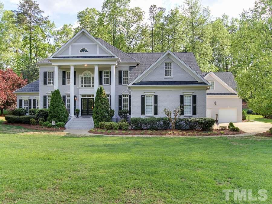 936 Oak Creek Road Raleigh, NC 27615 - Photo 1 of 25 a front view of a house with a yard and trees