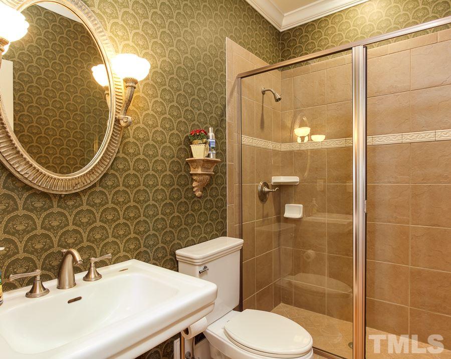 936 Oak Creek Road Raleigh, NC 27615 - Photo 11 of 25 a bathroom with a sink toilet and shower