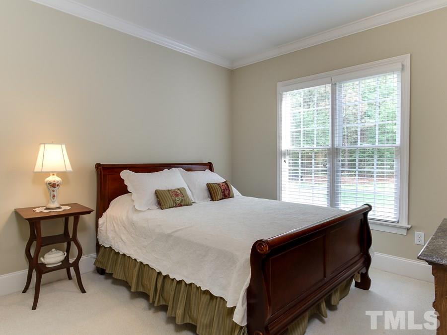 936 Oak Creek Road Raleigh, NC 27615 - Photo 12 of 25 a bedroom with a bed chair and a window