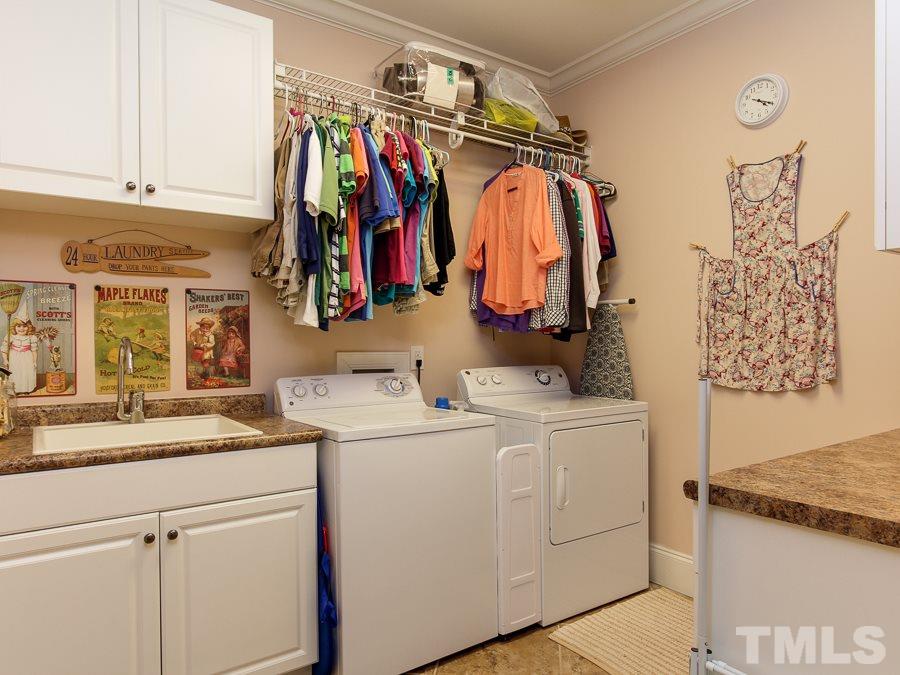 936 Oak Creek Road Raleigh, NC 27615 - Photo 13 of 25 a view of walk in closet with clothes