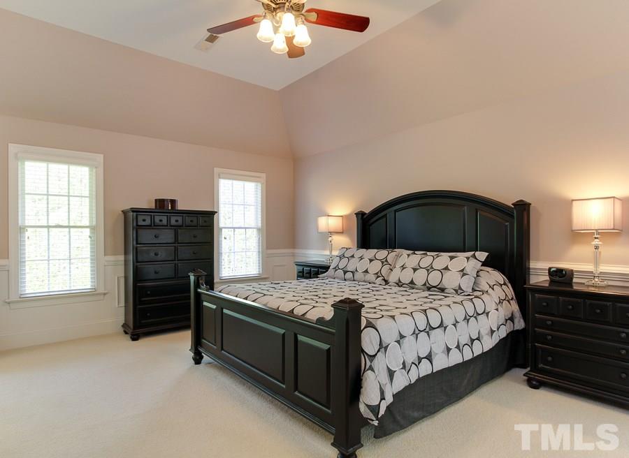 936 Oak Creek Road Raleigh, NC 27615 - Photo 14 of 25 a bedroom with a bed and a dresser
