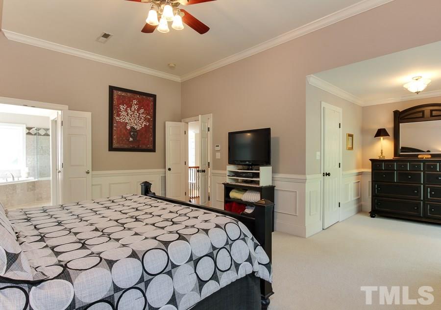 936 Oak Creek Road Raleigh, NC 27615 - Photo 15 of 25 a bedroom with a bed and a television