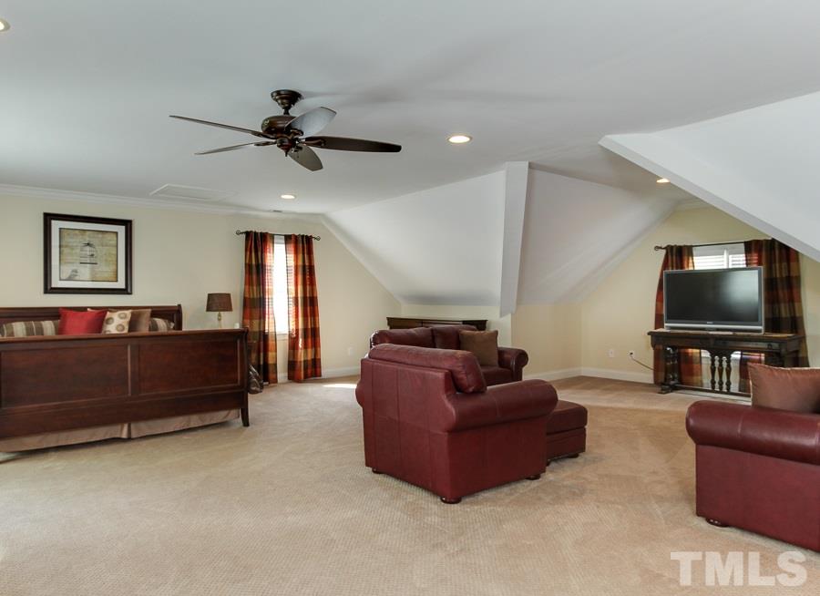 936 Oak Creek Road Raleigh, NC 27615 - Photo 17 of 25 a living room with furniture and a flat screen tv