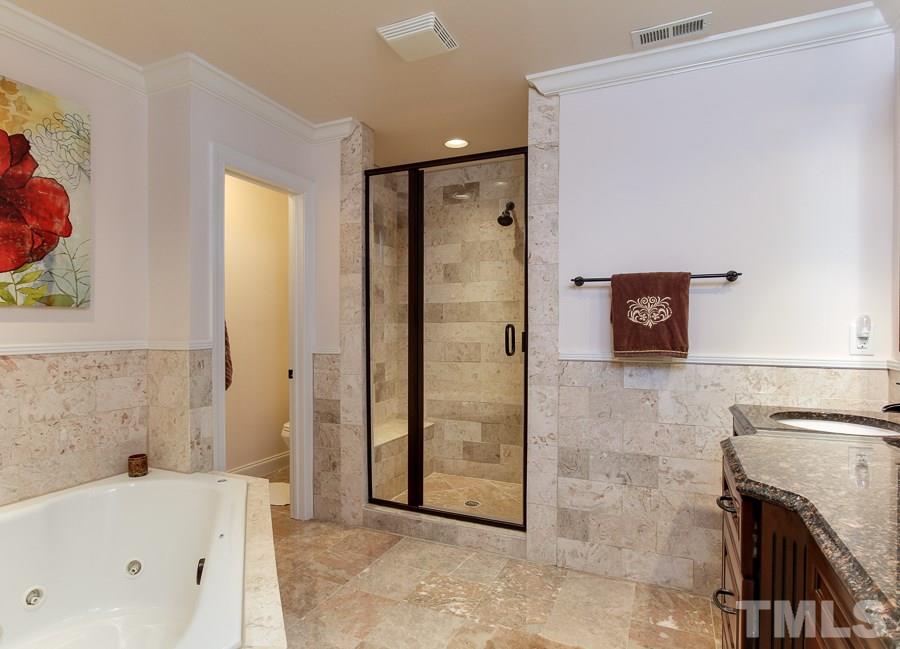 936 Oak Creek Road Raleigh, NC 27615 - Photo 19 of 25 a bathroom with a bathtub and a shower