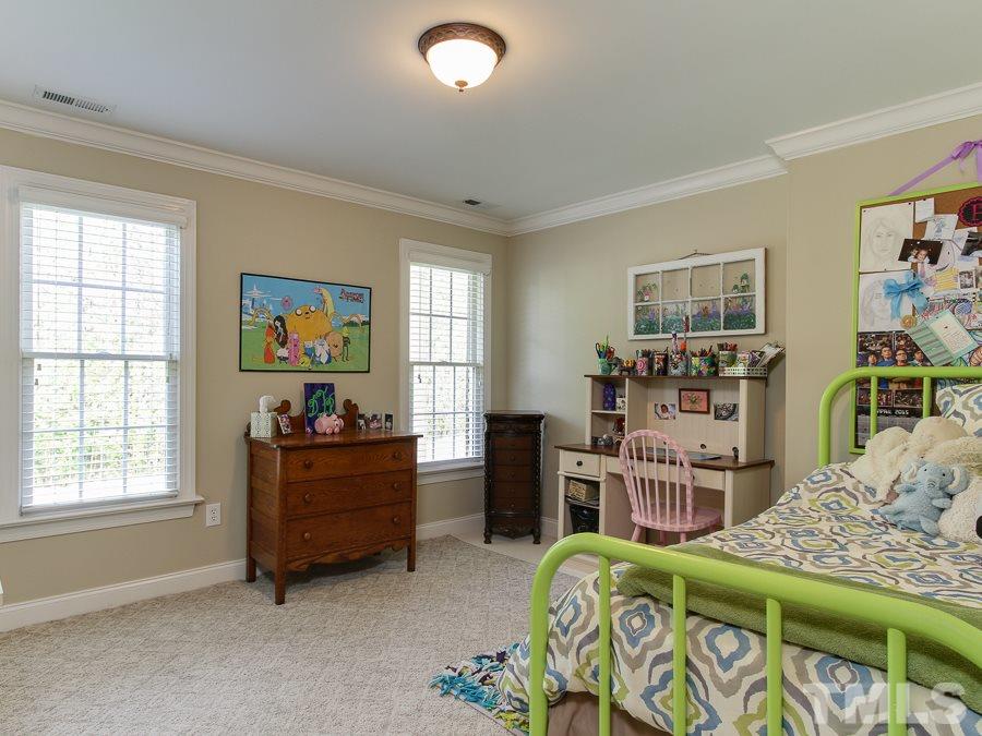 936 Oak Creek Road Raleigh, NC 27615 - Photo 20 of 25 a bedroom with furniture and a wooden floor