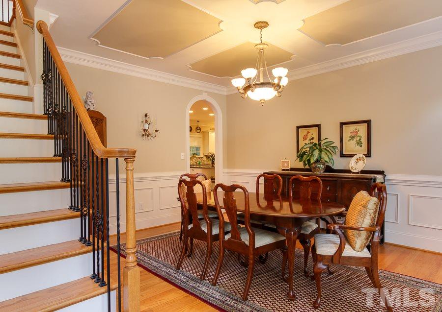 936 Oak Creek Road Raleigh, NC 27615 - Photo 3 of 25 a view of a dining room with furniture a chandelier and wooden floor