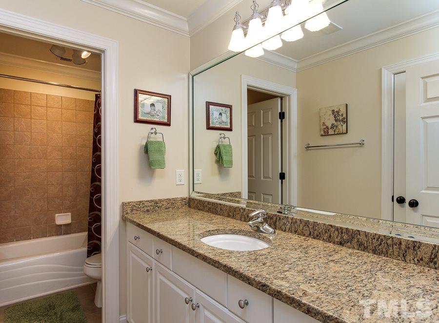 936 Oak Creek Road Raleigh, NC 27615 - Photo 21 of 25 a bathroom with a granite countertop sink and a mirror