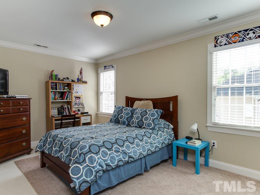 936 Oak Creek Road Raleigh, NC 27615 - Photo 22 of 25 a bedroom with a bed and a window
